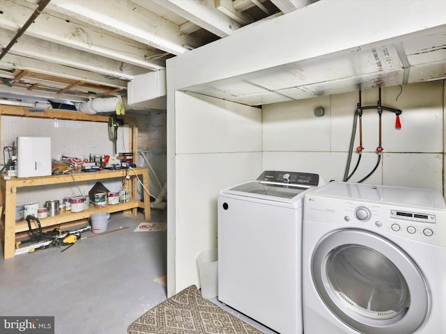 clothes washing area featuring washer and dryer