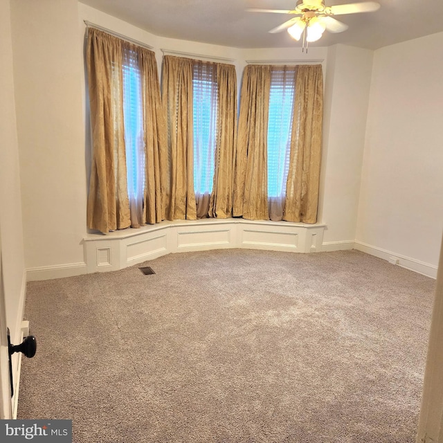 spare room with carpet flooring and ceiling fan