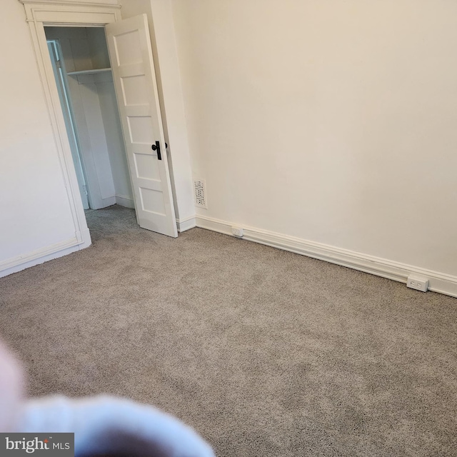 unfurnished bedroom featuring carpet floors and a closet