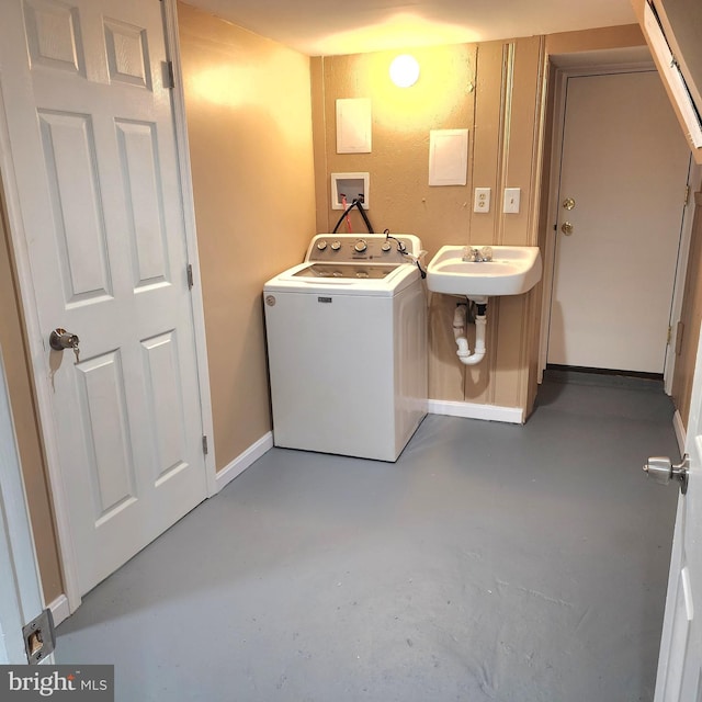 clothes washing area featuring washer / clothes dryer and sink