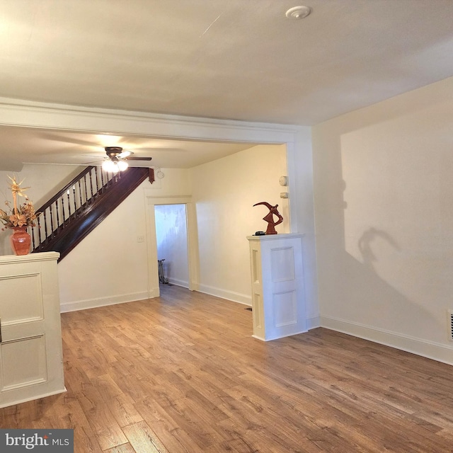 empty room featuring ceiling fan and light hardwood / wood-style floors