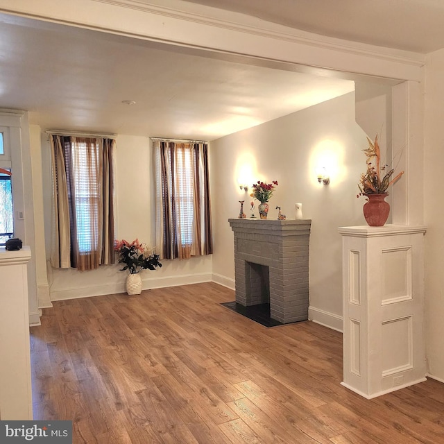 unfurnished living room with a fireplace, hardwood / wood-style floors, and plenty of natural light