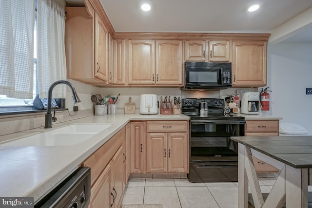 kitchen with black appliances, light tile patterned floors, sink, and light brown cabinetry