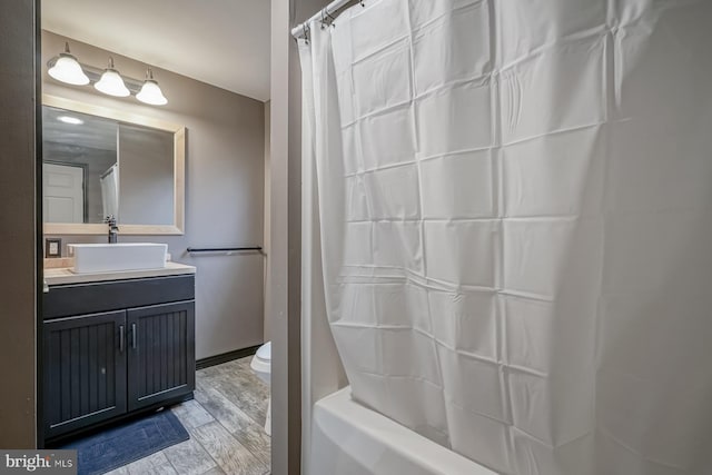 full bathroom with wood-type flooring, vanity, toilet, and shower / bath combo with shower curtain