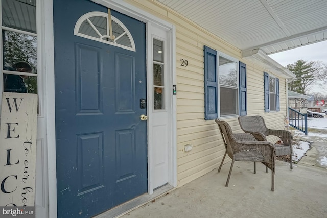 view of exterior entry with a porch