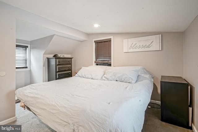 carpeted bedroom featuring lofted ceiling