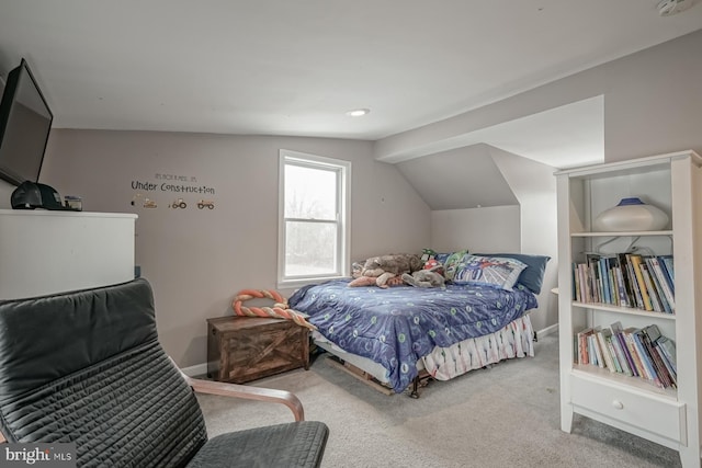 carpeted bedroom with lofted ceiling