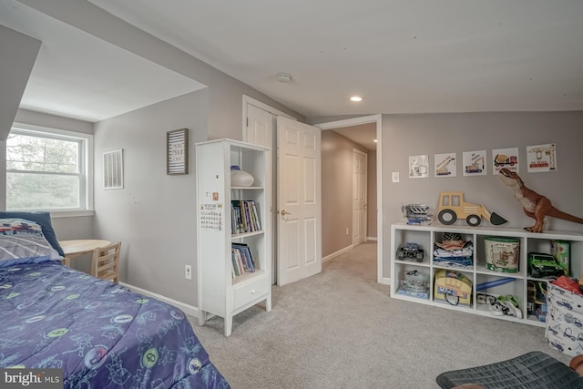 bedroom featuring light carpet and vaulted ceiling