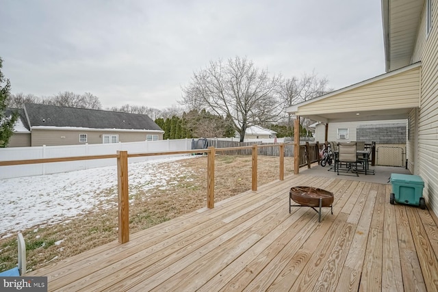 snow covered deck featuring a fire pit