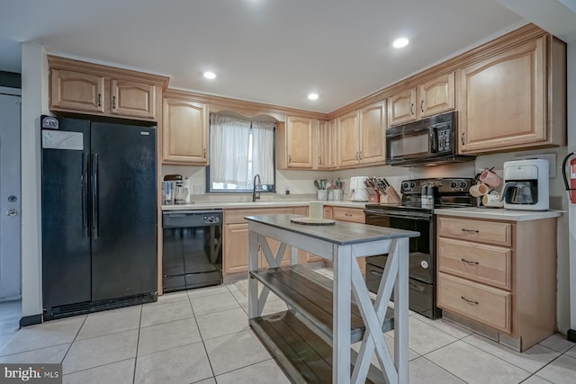 kitchen with light brown cabinetry, sink, light tile patterned floors, and black appliances