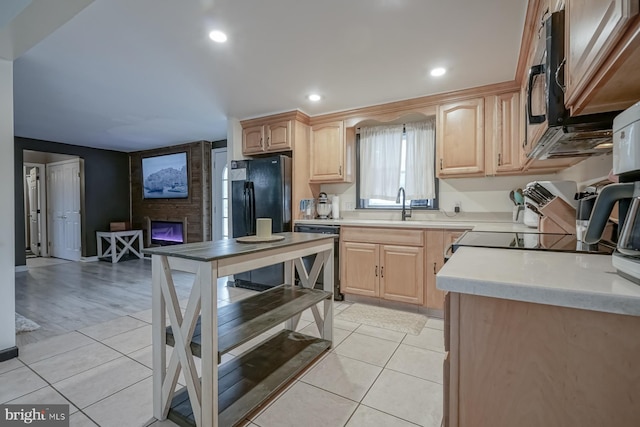 kitchen with dishwashing machine, light brown cabinets, and light tile patterned floors