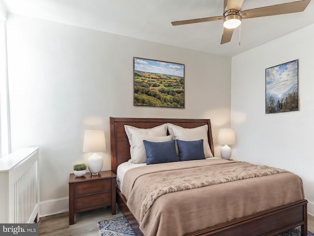 bedroom with light hardwood / wood-style flooring and ceiling fan