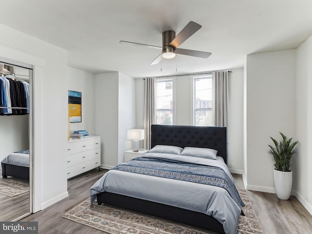 bedroom featuring wood-type flooring, a closet, and ceiling fan