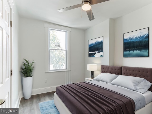 bedroom with ceiling fan and hardwood / wood-style floors