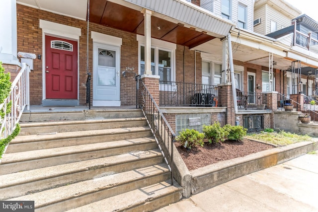 view of exterior entry featuring a porch