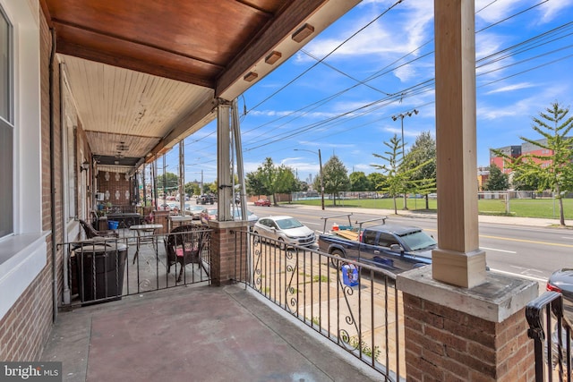 view of patio / terrace featuring central AC unit and a porch