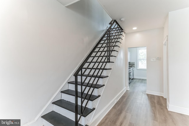 stairway with hardwood / wood-style flooring