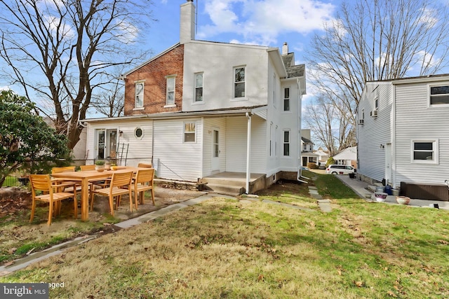 rear view of house with a yard