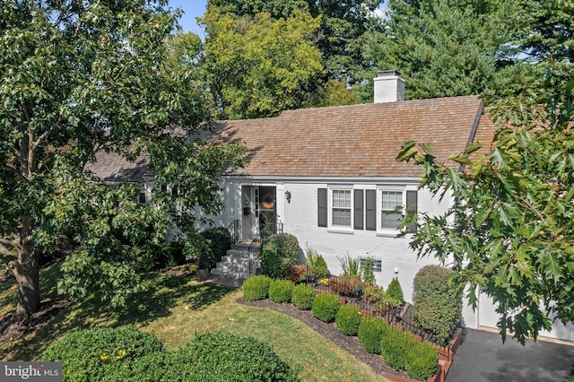 view of front of property with a front yard and a garage