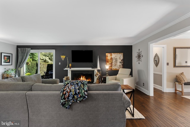 living room with dark hardwood / wood-style flooring and ornamental molding