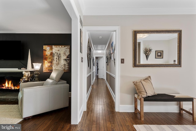 hall with hardwood / wood-style floors and ornamental molding