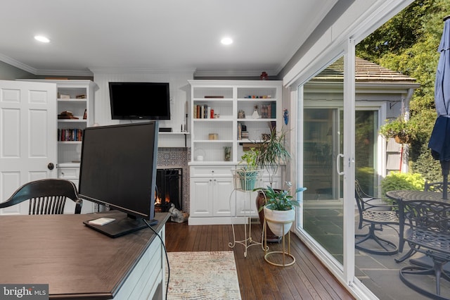 office area featuring dark hardwood / wood-style flooring, a wealth of natural light, and ornamental molding