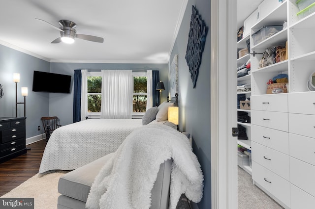 bedroom with dark hardwood / wood-style flooring, ceiling fan, and crown molding