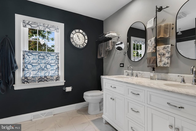 bathroom featuring vanity and toilet