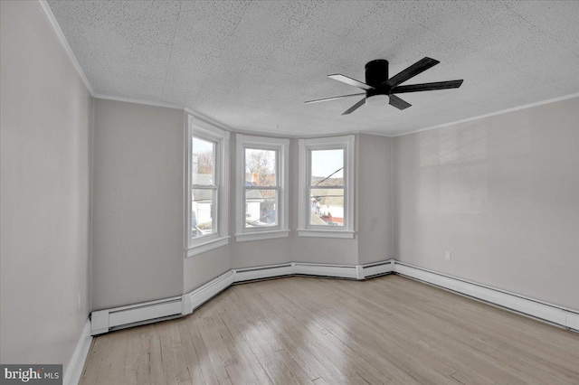 empty room featuring ceiling fan, light hardwood / wood-style floors, ornamental molding, and a textured ceiling