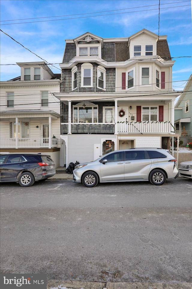 view of front of home featuring mansard roof