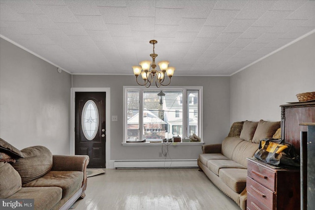 living area with a chandelier, light wood-type flooring, crown molding, and baseboard heating