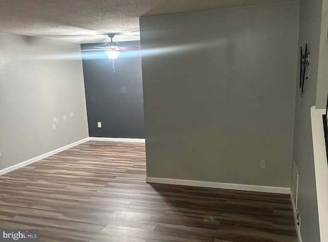 spare room with hardwood / wood-style floors, a textured ceiling, and ceiling fan