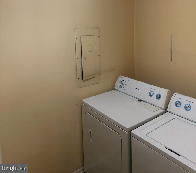 laundry area with separate washer and dryer and electric panel