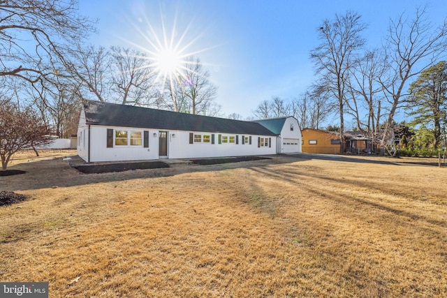 view of front facade with a front lawn and a garage