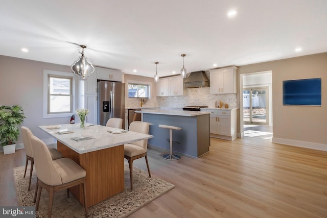 dining space featuring an inviting chandelier and light hardwood / wood-style flooring