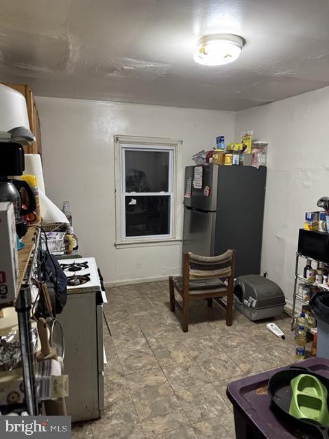 kitchen featuring range and stainless steel refrigerator