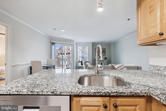 kitchen with light stone counters, ornamental molding, and sink