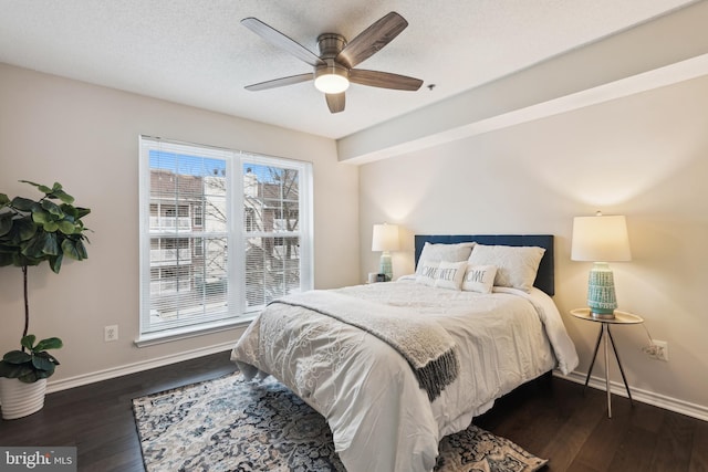 bedroom featuring multiple windows, dark hardwood / wood-style flooring, and ceiling fan