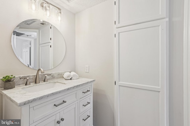 bathroom featuring vanity and a textured ceiling