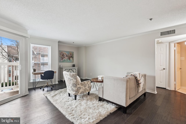 living room featuring a textured ceiling, crown molding, and dark wood-type flooring