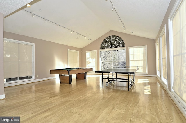 rec room with light hardwood / wood-style floors, vaulted ceiling, and pool table