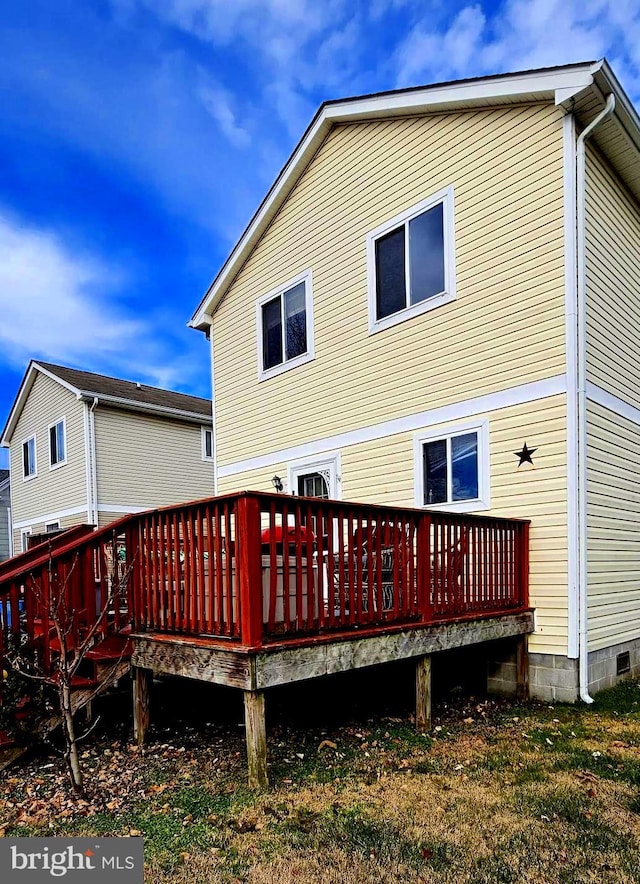 back of property featuring a wooden deck