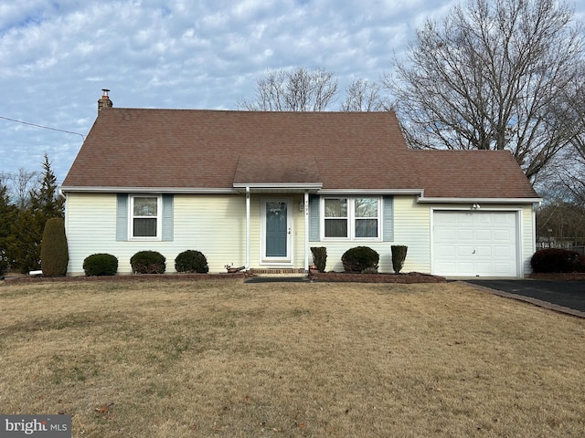 ranch-style house featuring a garage and a front lawn