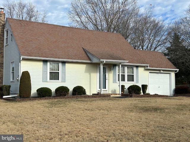 ranch-style home featuring a garage and a front lawn