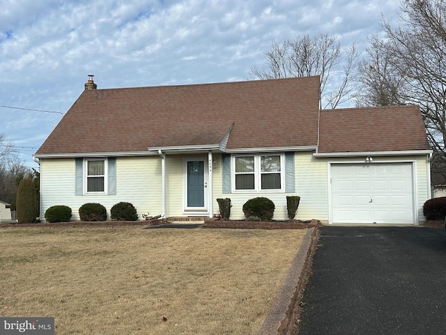 ranch-style house with a front yard and a garage