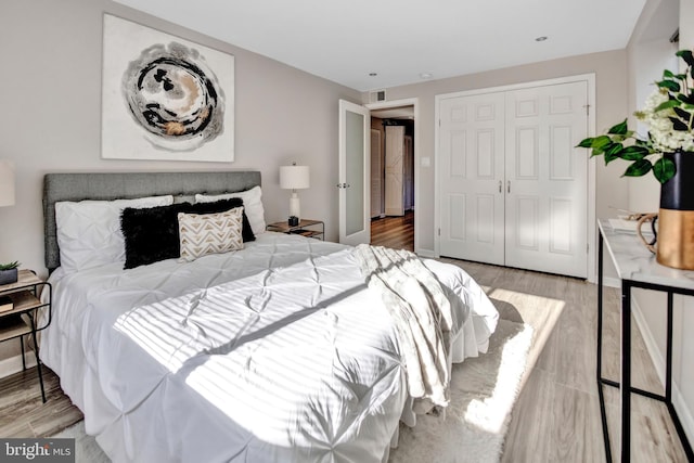 bedroom featuring a closet and light hardwood / wood-style floors