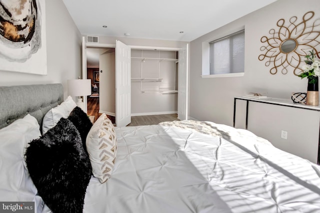 bedroom with light hardwood / wood-style floors and a closet