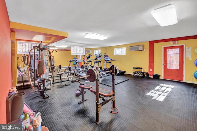 workout area featuring an AC wall unit