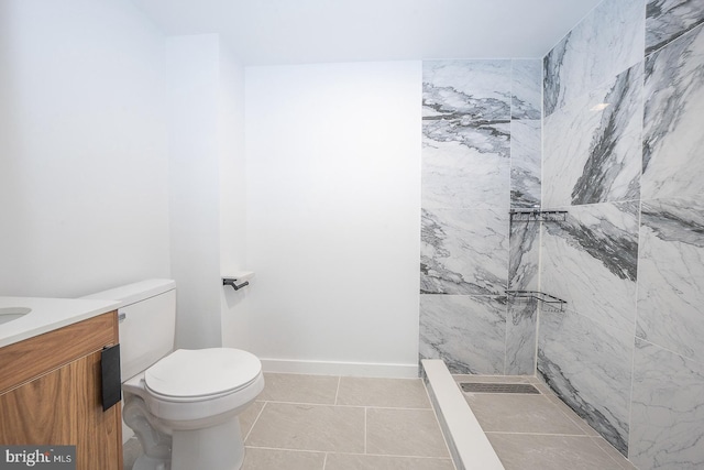 bathroom featuring a shower, tile patterned flooring, vanity, and toilet