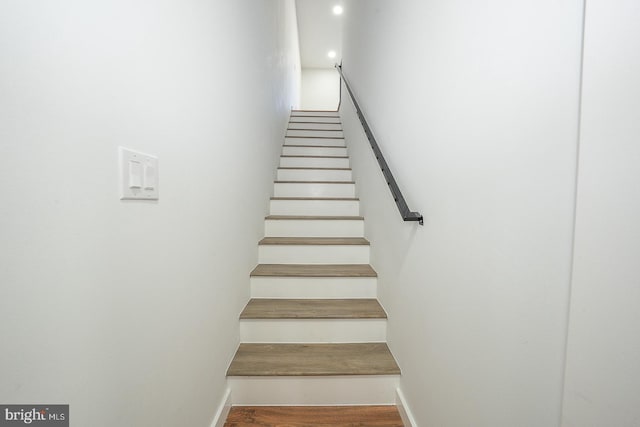 staircase featuring wood-type flooring